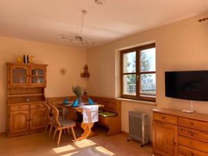 a room with a table and a tv and a desk at Apartment "Gabi" Sonnleitn/Nassfeld in Sonnenalpe Nassfeld
