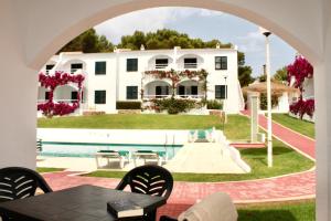 an archway view of a house with a pool at Playa Parc Apartments in Son Parc