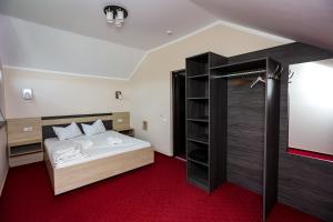 a bedroom with a bed and a walk in shower at Pensiunea Celestin in Eşelniţa +29 photos