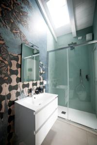 a bathroom with a sink and a glass shower at Bed & Breakfast A Mare in Fano