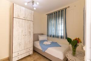 a small bedroom with a bed and a window at Voula Resort in Elafonisos