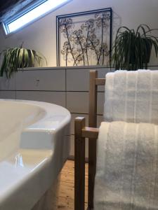 a bathroom with a bath tub and two towels at Clos de Bertinat in Saint-Sulpice-de-Faleyrens
