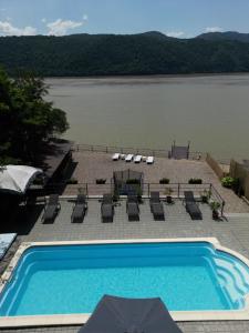 a swimming pool with a view of a lake at Pensiunea Celestin in Eşelniţa