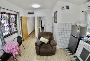 a living room with a chair and a refrigerator at Khod’s House in Chiang Mai +34 photos