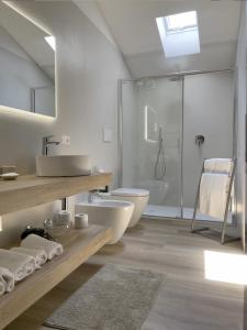 a bathroom with a sink and a toilet and a shower at Appartamenti Alighieri in Bardolino