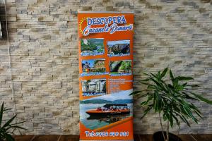 an orange banner hanging on a brick wall at Pensiunea Celestin in Eşelniţa