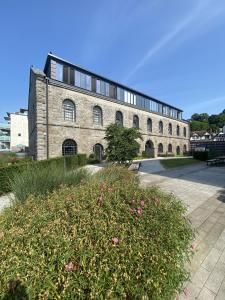 un grande edificio in mattoni con un cespuglio di fronte di Sublime waterfront retreat with private terrace a Bristol