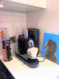 a kitchen counter with a coffee maker and a cup at Sublime waterfront retreat with private terrace in Bristol