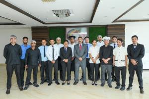 a group of men posing for a picture in a room at Hotel 7 Heaven in Dehradun