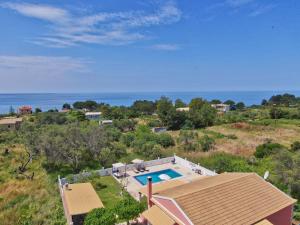 an aerial view of a house with a swimming pool at Angelloti Exclusive Beach Villa in Ágios Matthaíos