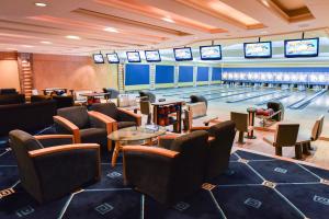 a bowling alley with lanes and tables and televisions at The Empire Brunei in Bandar Seri Begawan