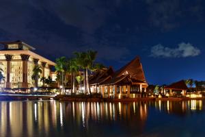 a building on the water at night at The Empire Brunei in Bandar Seri Begawan