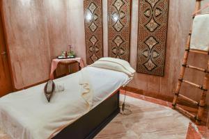 a bed in a room with a wall at The Empire Brunei in Bandar Seri Begawan