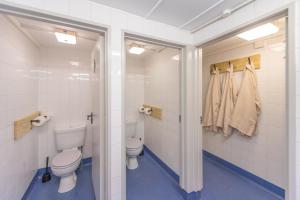 a bathroom with a toilet and a sink at Luxury Glamping at Stags Head in Abbotskerswell