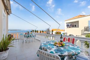 a table on a balcony with a view of the ocean at Unforgettable Return To Timeless Spetses in Spetses