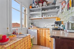 a kitchen with a sink and a counter top at Unforgettable Return To Timeless Spetses in Spetses