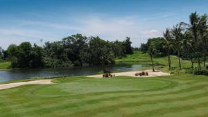 a view of a golf course with a river at The Empire Brunei in Bandar Seri Begawan