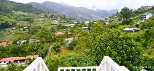 a small village on a hill with houses and trees at Dongorit Cabin Deluxe Room in Kampong Kundassan