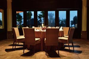 a dining room with a table and chairs at The Empire Brunei in Bandar Seri Begawan