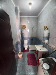 a bathroom with a sink and a toilet and a tub at شالية علي البحر بالعين السخنة بقرية امباير ريزورت in Ain Sokhna