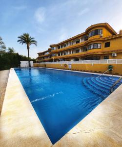 a swimming pool in front of a building at VILLA ARTEP Luxurious, sunny apartment with pool and large garden in Cartagena