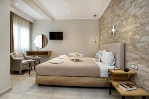 a bedroom with a bed and a stone wall at Le Vieux Quartier in Limenaria
