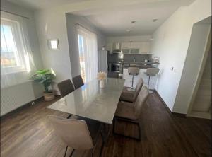 a living room with a dining table and a kitchen at Holiday home " MIA" in Gradina