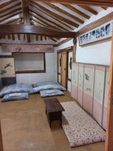 a large room with three beds and a table at Yasun Gallery in Gyeongju
