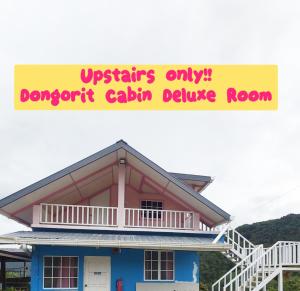 a house with a sign that reads upstairs onlyfficient calcium decline room at Dongorit Cabin Deluxe Room in Kundasang