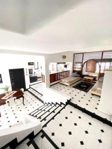 een woonkamer met een zwart-witte tegelvloer bij Villa avec jardin sur la plage - Complexe Al Amine in Fnidek