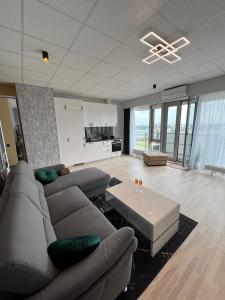 a living room with a couch and a coffee table at Krasta Home apartament Free Parking With CITY & RIVER VIEW in Rīga