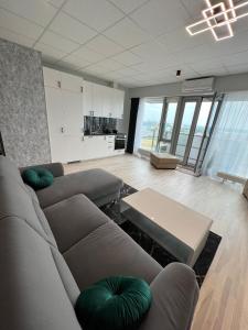 a large living room with a couch and a table at Krasta Home apartament Parking & With CITY & RIVER VIEW in Riga +41 photos
