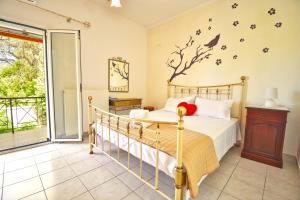 a bedroom with a bed with a bird on the wall at Angelloti Exclusive Beach Villa in Ágios Matthaíos
