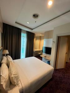 Postel nebo postele na pokoji v ubytování Jindagu Hotel Ipoh