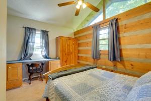 a bedroom with a bed and a wooden wall at Family-Friendly Afton Cabin with Spacious Yard! in Greeneville