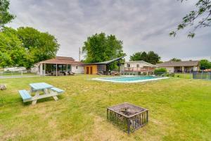 a backyard with a picnic table and a pool at Lakefront Washington Home with Private Pool and Sauna in Moses Lake
