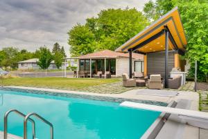 a swimming pool in front of a house at Lakefront Washington Home with Private Pool and Sauna in Moses Lake