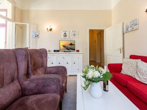 een woonkamer met een bank en een tv bij Villa Arcadia App 05 in Heringsdorf