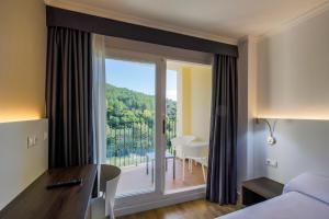 Postel nebo postele na pokoji v ubytování Hotel Rosaleda del Mijares
