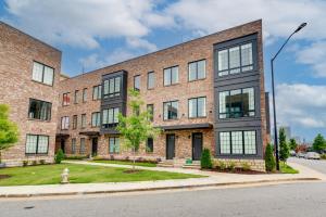 a brick building with windows on a street at Chic Atlanta Vacation Rental about 1 Mi to Downtown! in Atlanta
