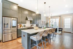 a kitchen with a large island with bar stools at Chic Atlanta Vacation Rental about 1 Mi to Downtown! in Atlanta