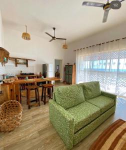 a living room with a green couch and a table at Big Furaha Villa in Kidoti