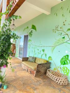 Big Furaha Villa في Kidoti: غرفة معيشة مع أريكة في غرفة بها نباتات