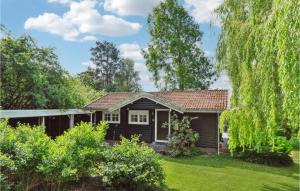 a small house in a yard with trees at 3 Bedroom Stunning Home In Dronningmlle in Dronningmølle