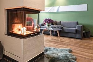 a living room with a fireplace and a couch at Kitzbühel Residences in Kitzbühel