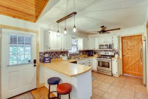 a kitchen with white cabinets and a wooden counter top at Woodsy Gassville Getaway about 3 Mi to White River! in Gassville