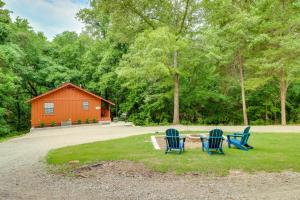 two chairs and a table in front of a house at Woodsy Gassville Getaway about 3 Mi to White River! in Gassville