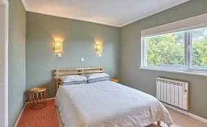 a bedroom with a bed and a window at Howlyek, in St Agnes Village in St. Agnes 