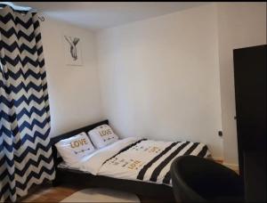 a small bedroom with a bed with two pillows at Wohnung im Zentrum von Darmstadt in Darmstadt