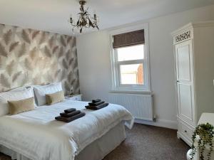 a bedroom with a white bed with towels on it at Apartment 33 Lytham in Lytham St Annes